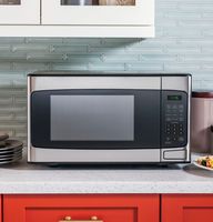 GE - 1.1 Cu. Ft. Mid-Size Microwave with Included Pasta/Veggie Cooker - Stainless Steel - Left View